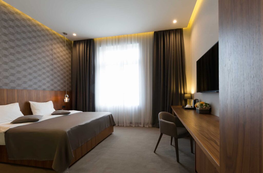 Guest room furniture manufacturer in Turkey showcasing modern hotel bedroom with bed, desk, TV unit and custom finishes.