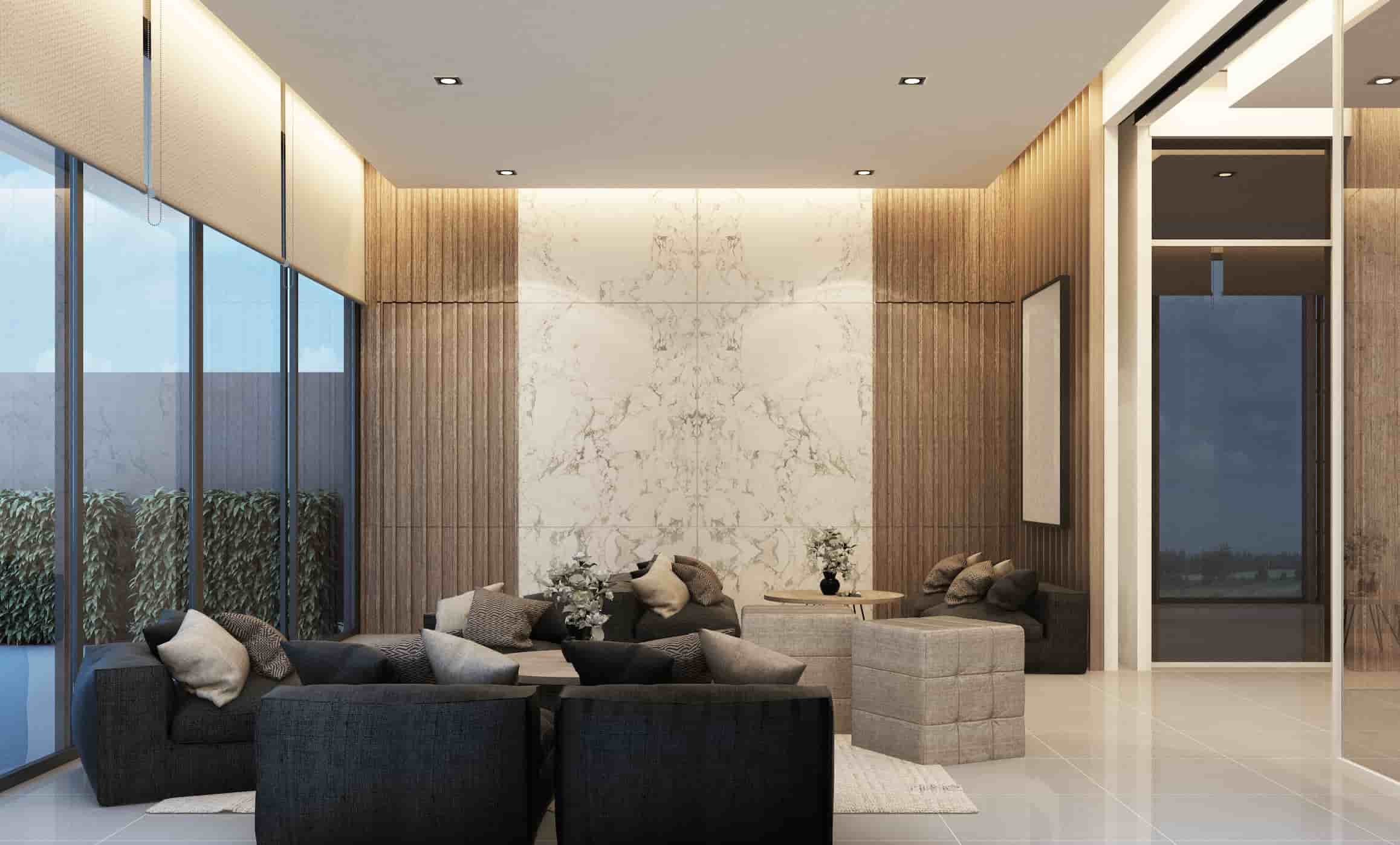 Elegant hotel lobby seating area with upholstered lounge chairs, marble accent wall, and warm wood paneling.