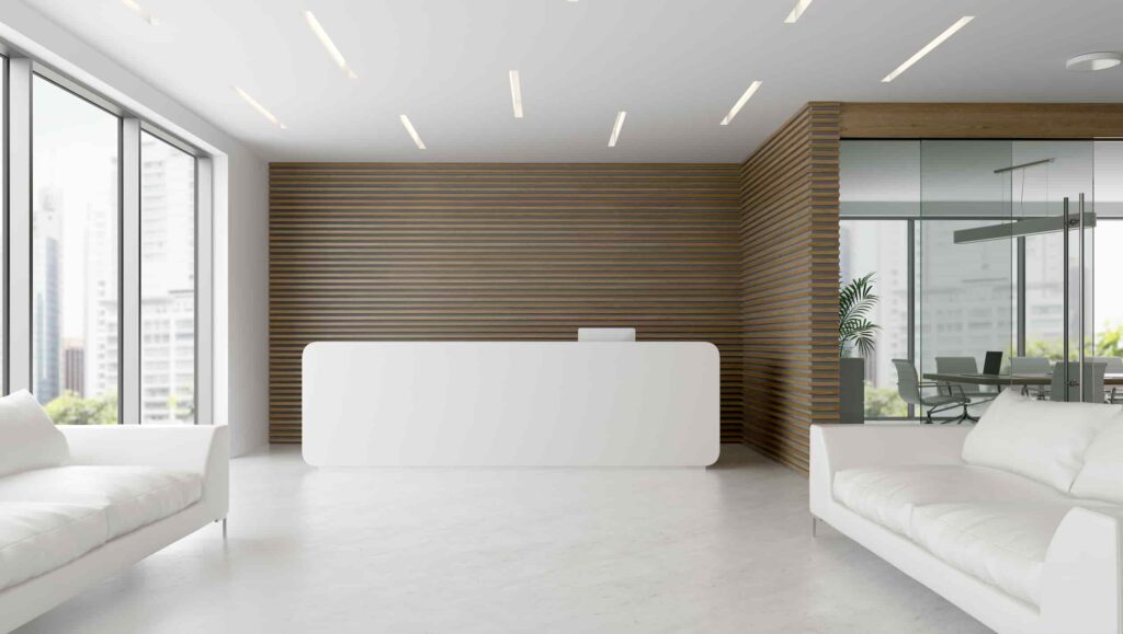 white reception desk with two sofas