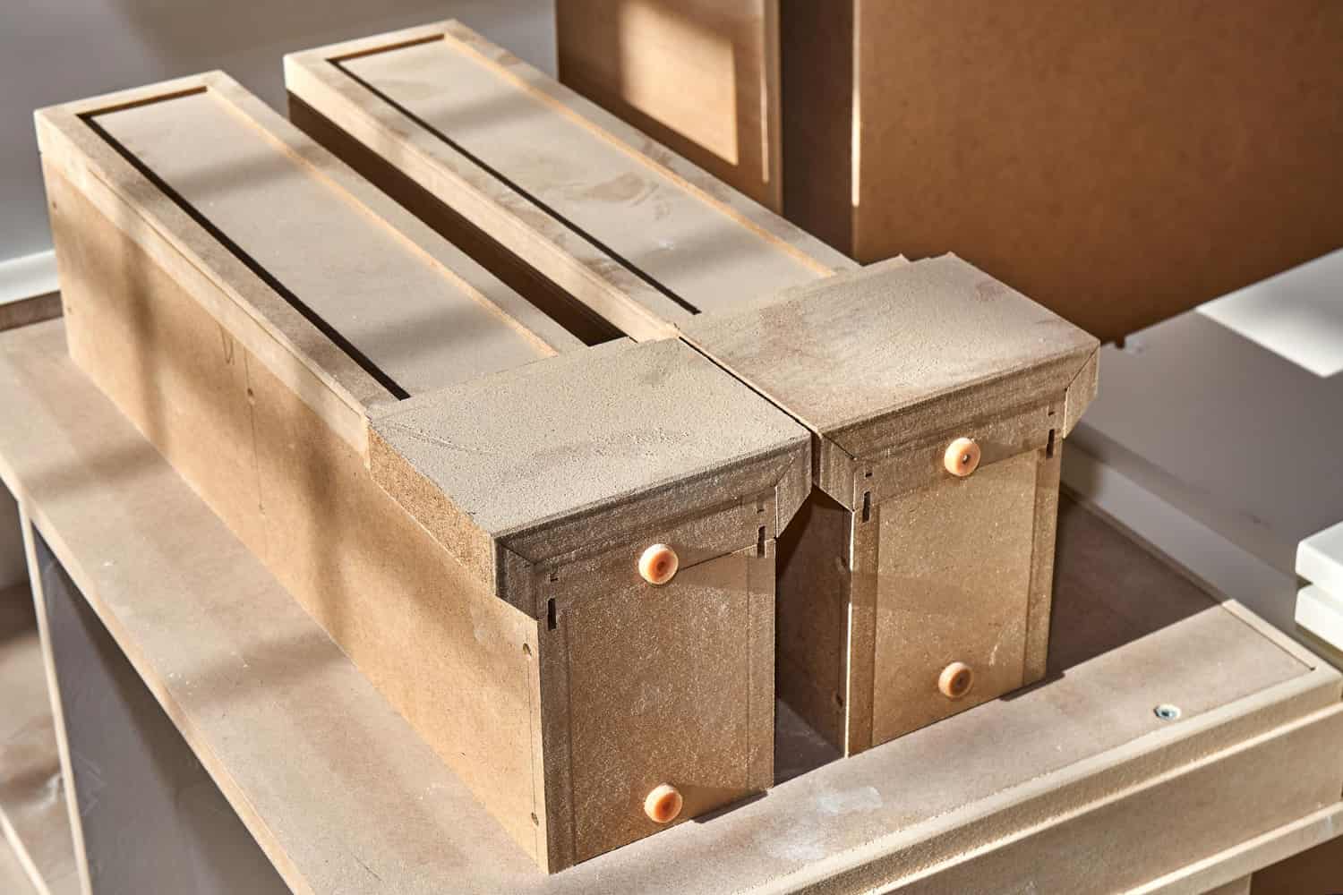 Hotel furniture wood materials MDF — casegood drawer units in raw MDF before surface finishing in Turkish factory