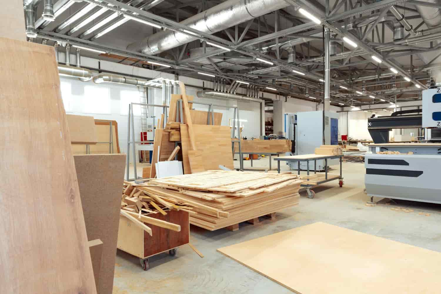 Turkish hotel furniture factory direct — production floor showing MDF panels, solid wood components and CNC machinery